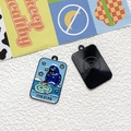 Detail of tarot 'The Star' enamel bird pendant with radiating sun pattern on black back - The Star