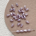 Macro detail of faceted purple glass beads with metallic finish for DIY jewelry making - Purple