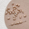 Macro view of rose gold faceted metal beads for DIY jewelry and beaded necklaces - Orange