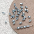 Close-up of light blue faceted glass beads with gold plated finish for DIY jewelry making - Blue