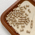 Dettaglio di perline distanziatrici in bambù dorato lucido per gioielli fai-da-te - Taglia 7 / 1 Pezzo / Oro