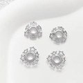 Macro detail of silver star-shaped flower bead caps for DIY jewelry making - White Gold