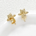 Macro shot of gold-plated flying dragon charms with intricate scale textures on a white tray - 18K Gold Plated Style / Gold