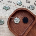 Macro detail of 17mm fan-shaped resin jewelry pieces with dark green bamboo leaf pattern - Round Petal Style