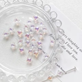 Macro detail of star-shaped iridescent glass beads for DIY jewelry making accessories - Iridescent White