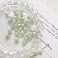 Macro detail of mint green square Czech glass beads with pearlescent finish for DIY jewelry - Mint Green