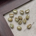 Detailed close-up of coffee bean shaped glass beads showing gradient olive color and hole - Gradient Olive (2#)