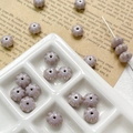 Macro detail of lilac pumpkin-shaped Czech glass beads with gold lining for DIY jewelry - Purple Pumpkin Style (3#)