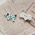 Macro shot of handmade ceramic spotted dog beads with two holes for DIY jewelry - Style 1