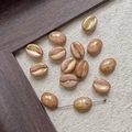 Macro shot of pink and gold coffee bean beads for DIY jewelry making with pre-drilled holes - Pearlescent Pink Gold (11#)