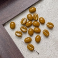 Macro detail of coffee bean glass beads with gold crackle texture and functional drill hole - Glossy Deep Coffee (12#)