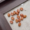 Detail of coffee bean shaped DIY beads with marble texture for jewelry making - Warm Marble (13#)