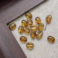 Macro shot of amber glass coffee bean beads with gold metallic groove detail for DIY crafts - Transparent Gold Amber (15#)