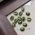 Macro shot of coffee bean shaped glass beads with antique bronze and gold textured finish - Bronze Mottled (18#)