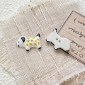 Macro shot of hand-painted ceramic dalmatian puppy buttons for DIY jewelry making - Style 7