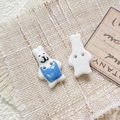 Macro detail of hand-painted rabbit ceramic buttons with two holes for DIY jewelry - Style 14