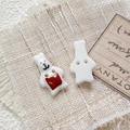 Macro shot of hand-painted ceramic rabbit buttons with cute black and red heart patterns - Style 16