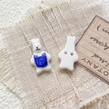 Close-up of hand-painted ceramic rabbit buttons with two holes for DIY jewelry - Style 17