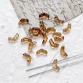 Macro detail of amber V-shaped chevron glass beads with marbled leopard print texture - Amber Marble