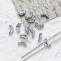 Macro detail of silver V-shaped two-hole Czech glass beads for DIY jewelry making - Bright Silver
