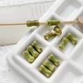 Macro detail of green spotted bone-shaped ceramic beads for DIY jewelry making - 2# Green Spotted Style (D5347) / 1 Piece