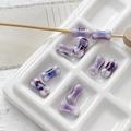 Detailed view of lavender bone-shaped ceramic beads with floral patterns in a white tray - 9# Light Purple White Gradient Style (D5347) / 1 Piece