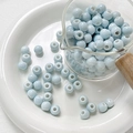 Macro shot of light blue glazed ceramic beads in a glass cup for DIY jewelry making - Style 4 (8mm/10 Pieces/Pack)