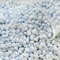 Macro detail of 4mm blue and white marble glass seed beads with gold glitter accents - 10g Pack / Color 2 (Blue and White Texture)