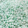 Macro shot of 4mm mint green marble glass beads with gold foil for DIY jewelry making - 10g Pack / Color 7 (Mint Green Texture)