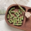 Detail of green bamboo-shaped ceramic beads with speckled glaze on a rustic wooden tray - Green Glossy Glaze Spotted Style (11#) / 1 Piece