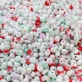 Macro shot of 4mm cream-textured glass beads with colorful ink patterns for DIY jewelry - 10g Pack / Color 11 (Emerald Ink Splash)