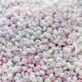 Macro view of 4mm cream marble glass beads with gold glitter for DIY jewelry making - 10g Pack / Color 10 (Pink White Green Smudge)