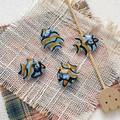 Macro view of four hand-painted ceramic tropical fish beads for DIY jewelry making - 6# (Sky Blue Orange Black Stripes)