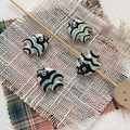 Macro detail of hand-painted ceramic tropical fish beads for DIY jewelry making - 15# (Black White Green Waves)