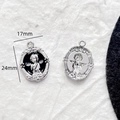 Detailed macro view of 24mm vintage angel relief pendants with baroque floral borders - Oval Angel Embossed (4#)