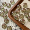 Macro detail of round light green Czech glass beads with copper bird patterns for DIY jewelry - Light Green Bird Style / 1 Piece Pack