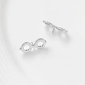 Detailed view of silver minimalist round glasses shaped stud earrings on a white surface - White Gold