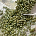 Macro detail of olive green Czech glass beads with vintage texture spilling from a glass - 4# / 10 Pieces Pack