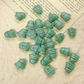 Macro detail of green bell-shaped Czech glass beads with white stripes for DIY jewelry - Green Style (6#)