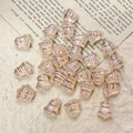 Macro shot of champagne gold bell-shaped Czech glass beads with hand-painted white stripes - Champagne Gold Style (10#)