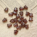 Macro detail of dark brown bell-shaped glass beads with gold stripes on vintage paper - Dark Brown Gold Pattern Style (30#)