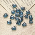 Macro detail of blue bell-shaped Czech glass beads with antique gold etched lines for DIY - Translucent Blue Gold Style (33#)