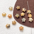 Macro shot of star-shaped natural stones with polished textures and pre-drilled holes - Agate
