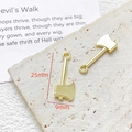 Macro detail of a 25mm golden alloy axe charm pendant with a top ring for DIY jewelry - Axe (4#)