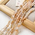 Macro shot of oval natural agate beads with oily luster on a rustic linen background - 1 Piece / Creamy Pink Orange Style (2#)