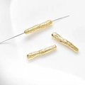 Macro shot of 14k gold-filled irregular long tube beads with hammered texture for DIY jewelry - 18K Gold