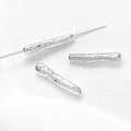 Macro detail of silver irregular textured twig tube spacer beads with center hole - Silver