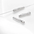 Macro shot of silver textured bar beads with irregular organic finish for DIY jewelry - White Gold