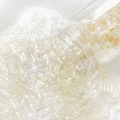 Detailed macro view of 6mm cream iridescent bugle beads pouring from a glass jar - 2# Creamy White Iridescent