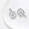 Macro view of silver color mother-of-pearl cross pendant with detailed zircon inlay detail - White Gold
